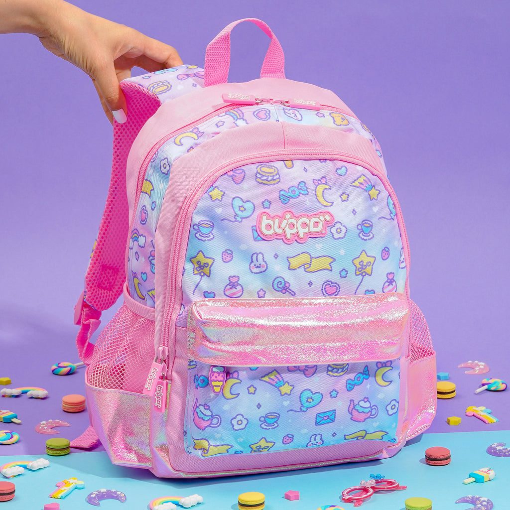 Holding a cute girls’ backpack for school. Featuring pink kawaii designs.