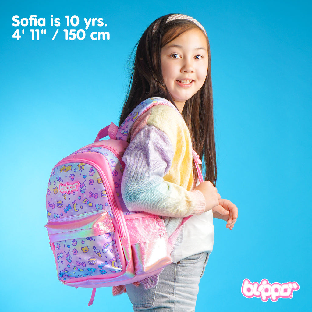 Girl wearing a backpack for preschool. Pink cute design with three compartments.