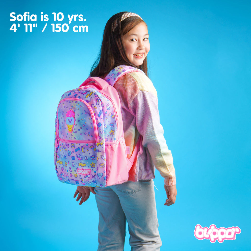 Girl wearing a kawaii school backpack. Pink cute design with three compartments.